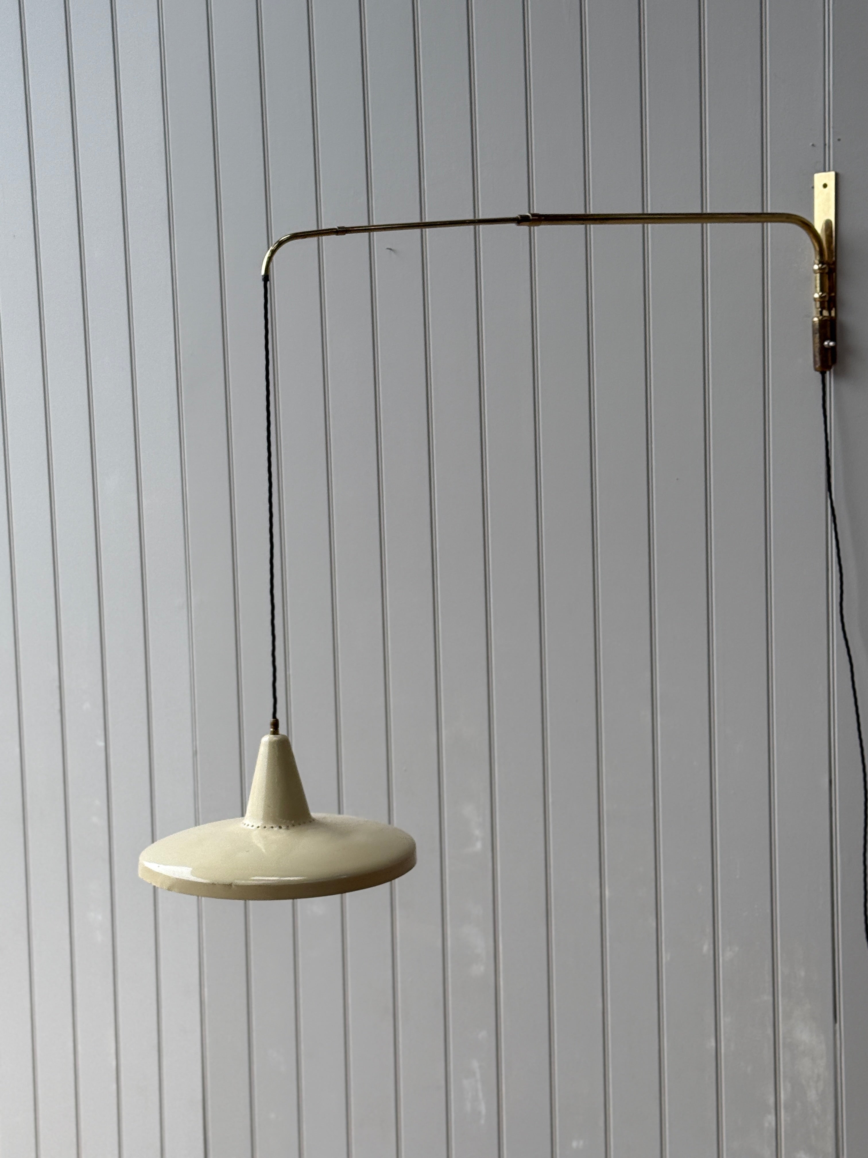 Italian 1950s Extending Brass Wall light with Yellow Toleware shade.