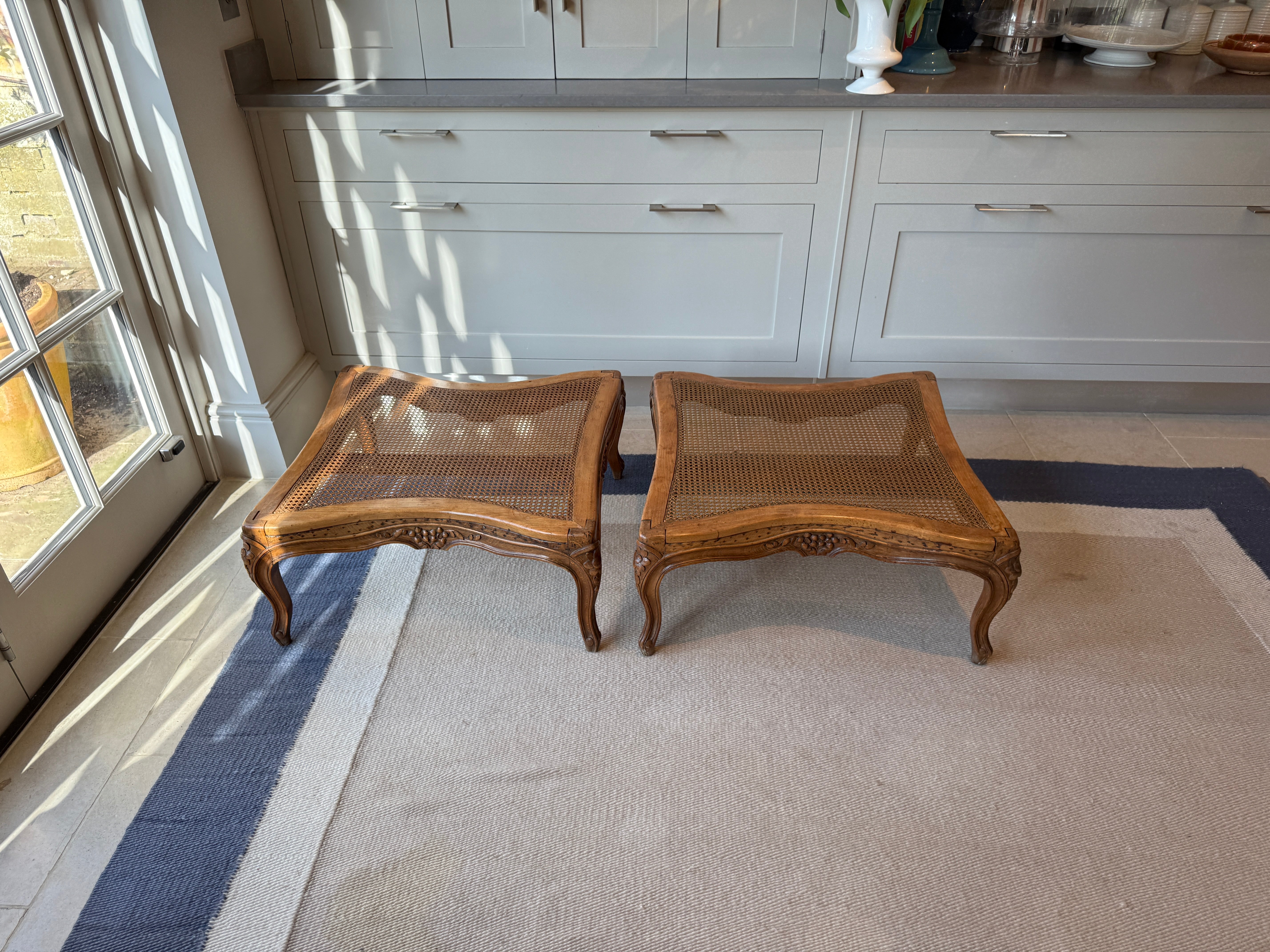 Pair of low French fruitwood and cane coffee table