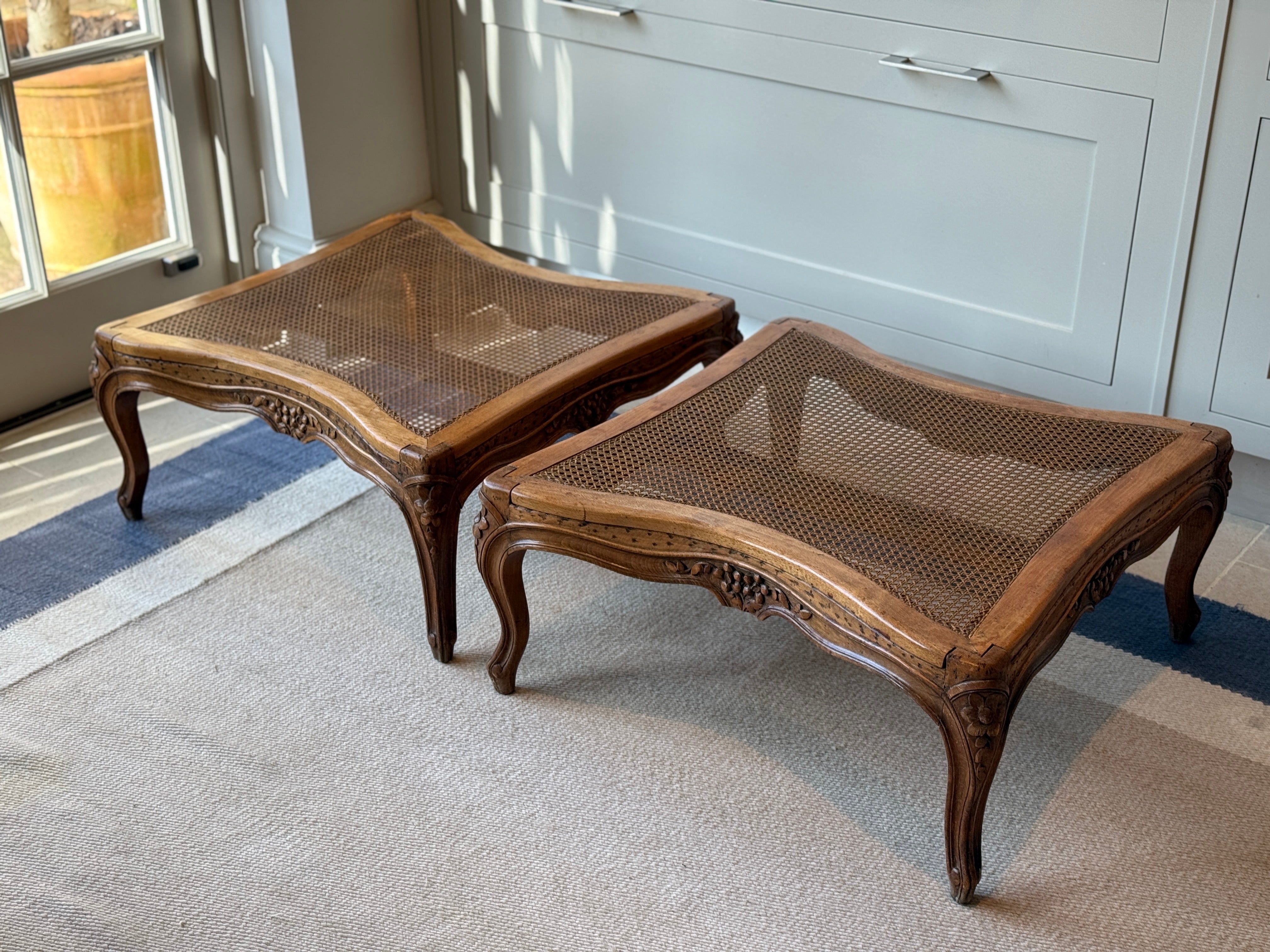 Pair of low French fruitwood and cane coffee table