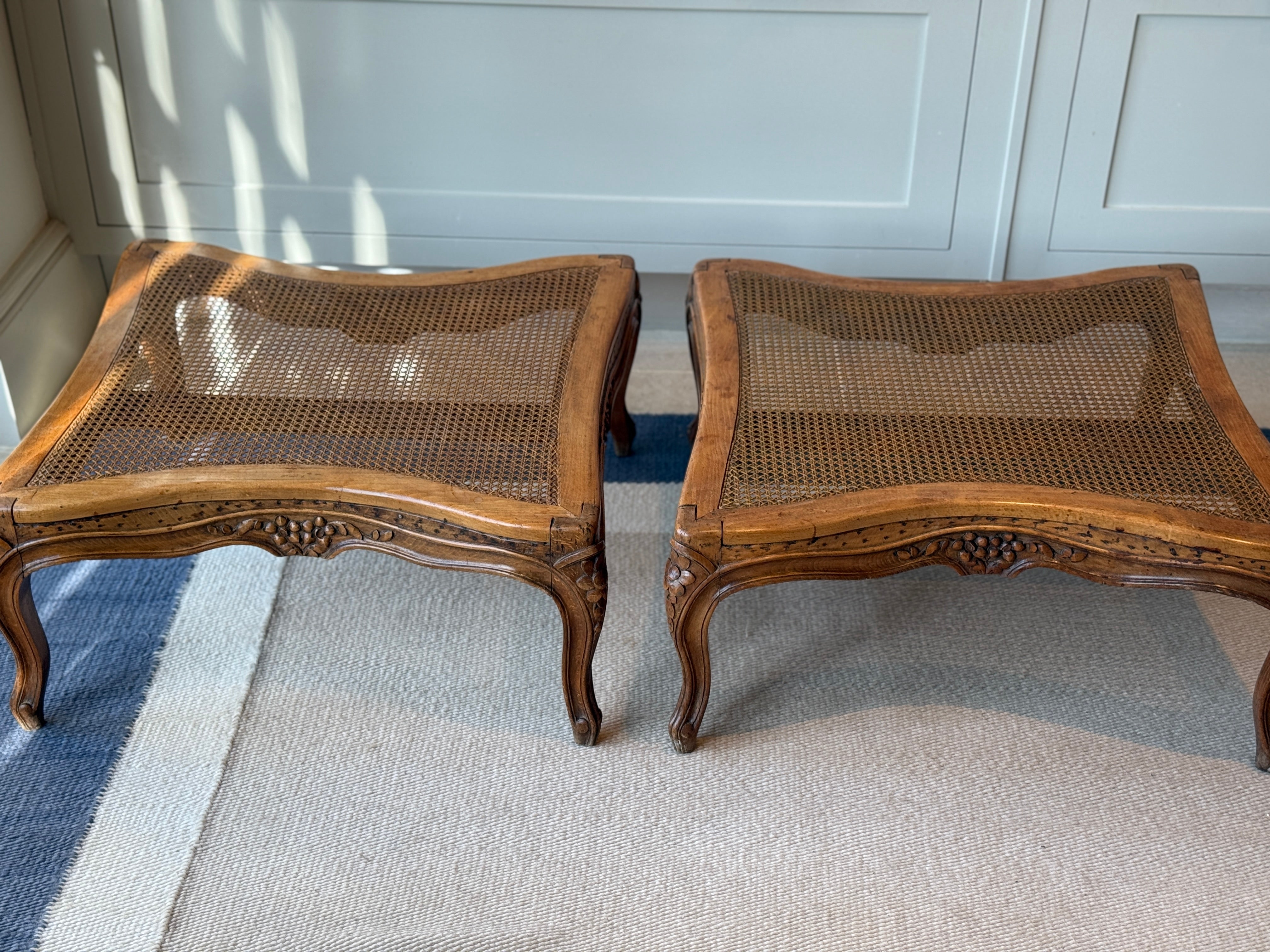 Pair of low French fruitwood and cane coffee table