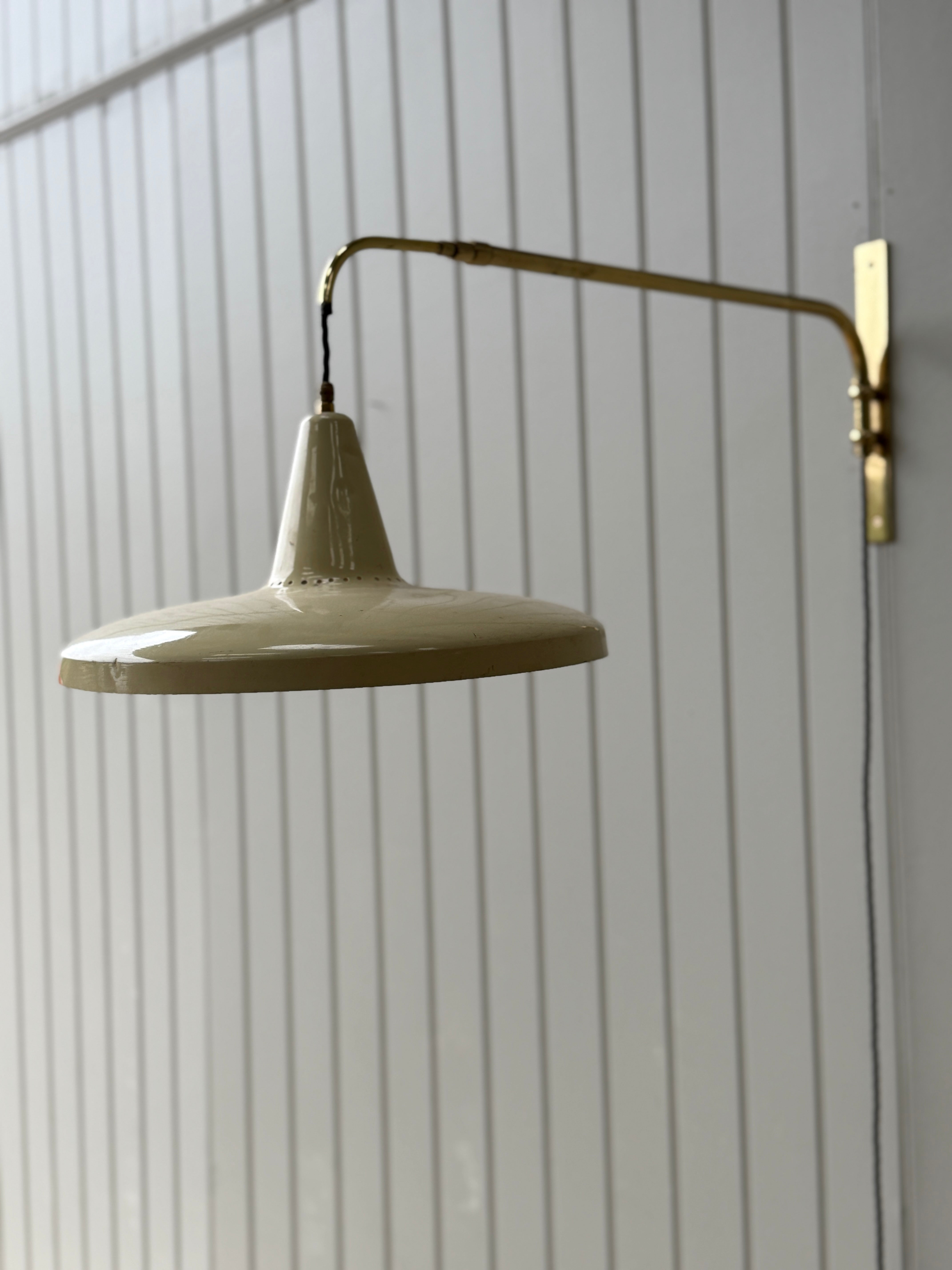 Italian 1950s Extending Brass Wall light with Yellow Toleware shade.