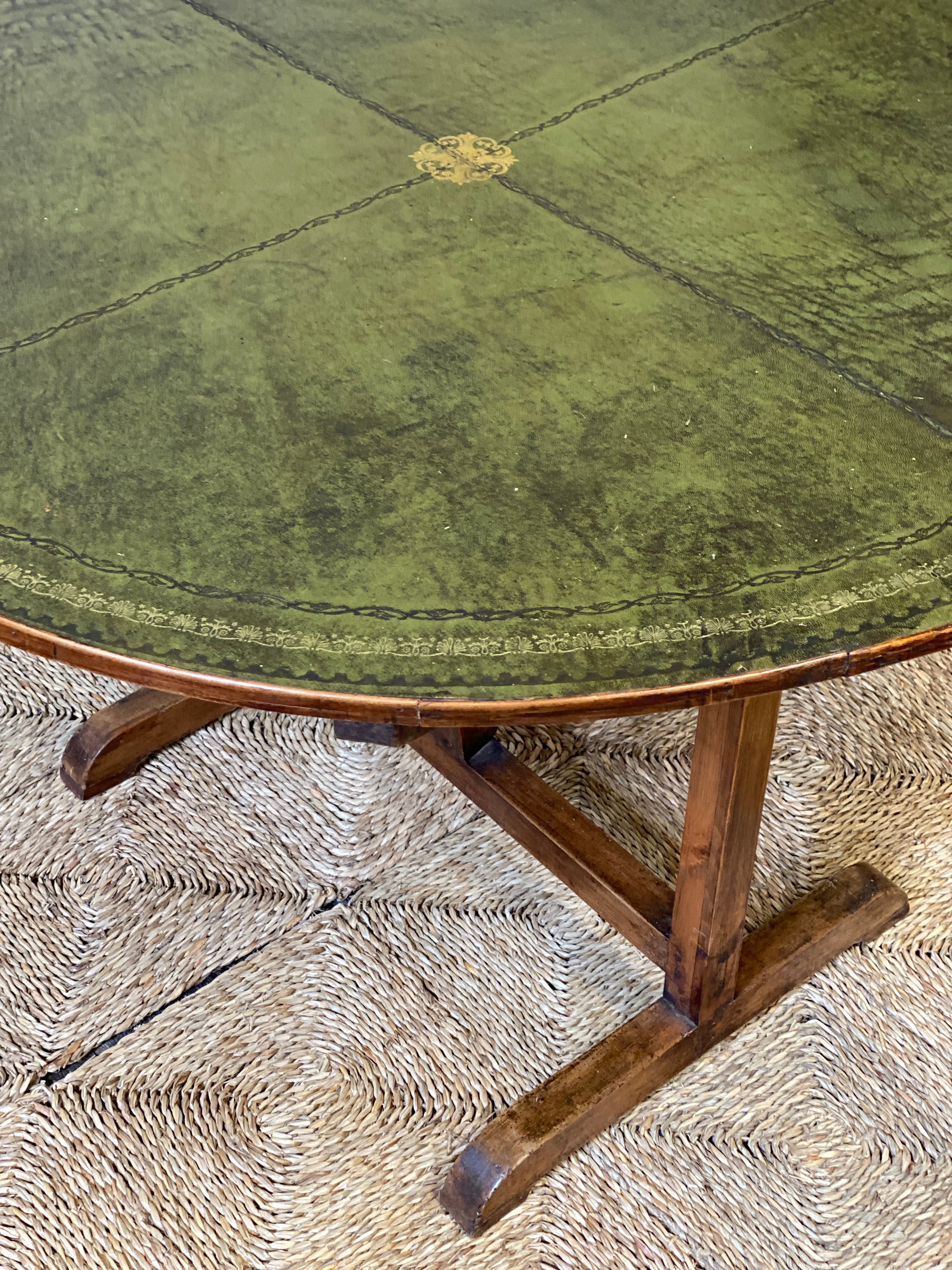 Early C20th French vendange wine table with green leather top.