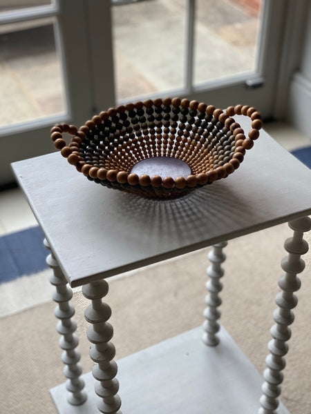 Small decorative bowl or basket constructed of wooden beads