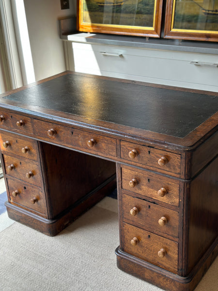 Antique Oak Desk with leather top on castors