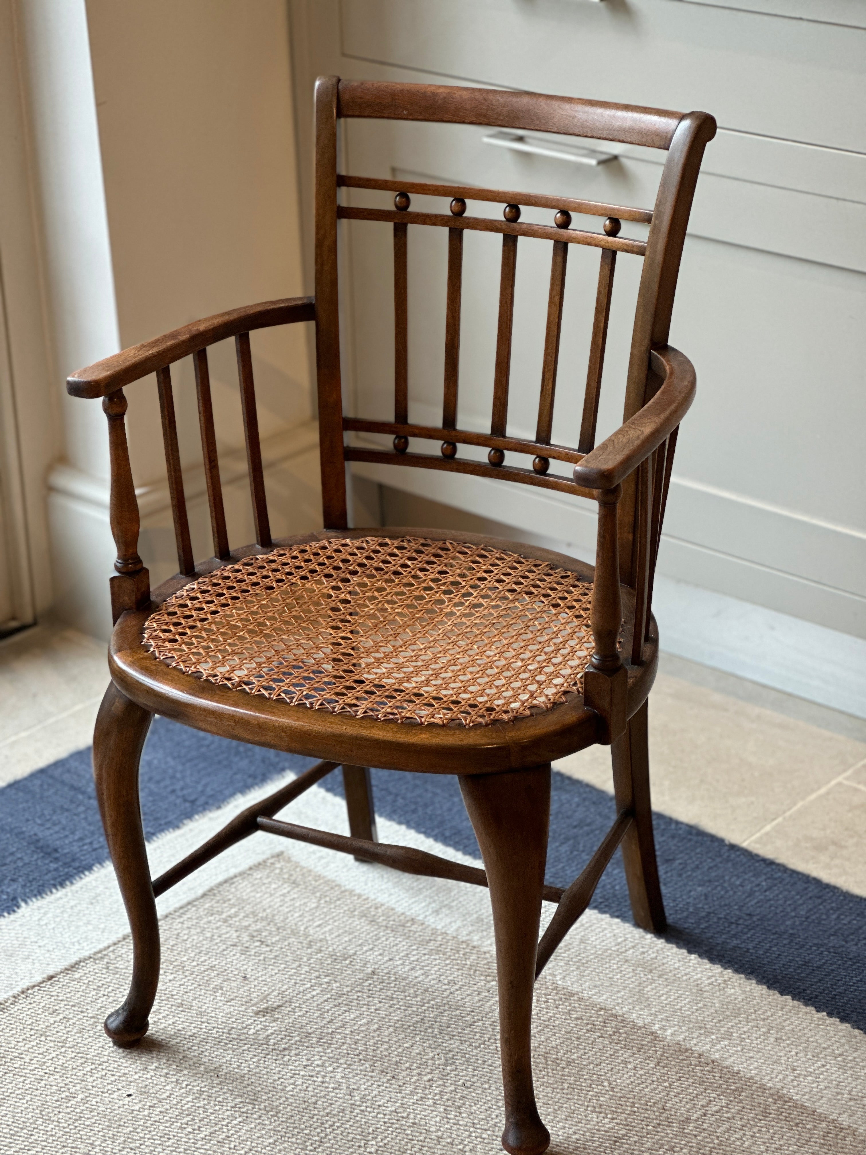 A Small Vintage JAS Shoolbred & Co Spindle Chair with Cane