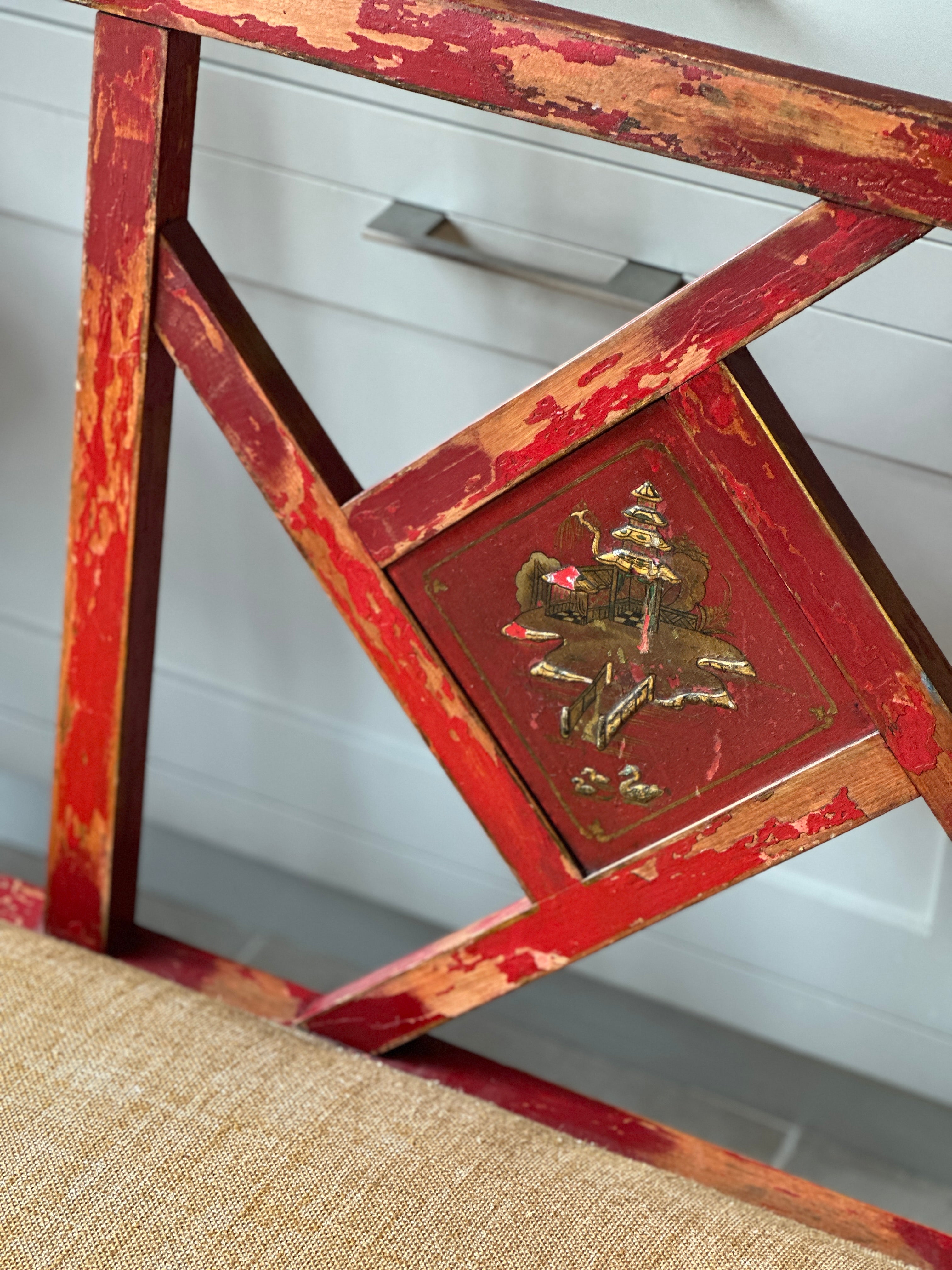 Charming Red Chinoiserie Sofa/Bench with well worn decorative paintwork.