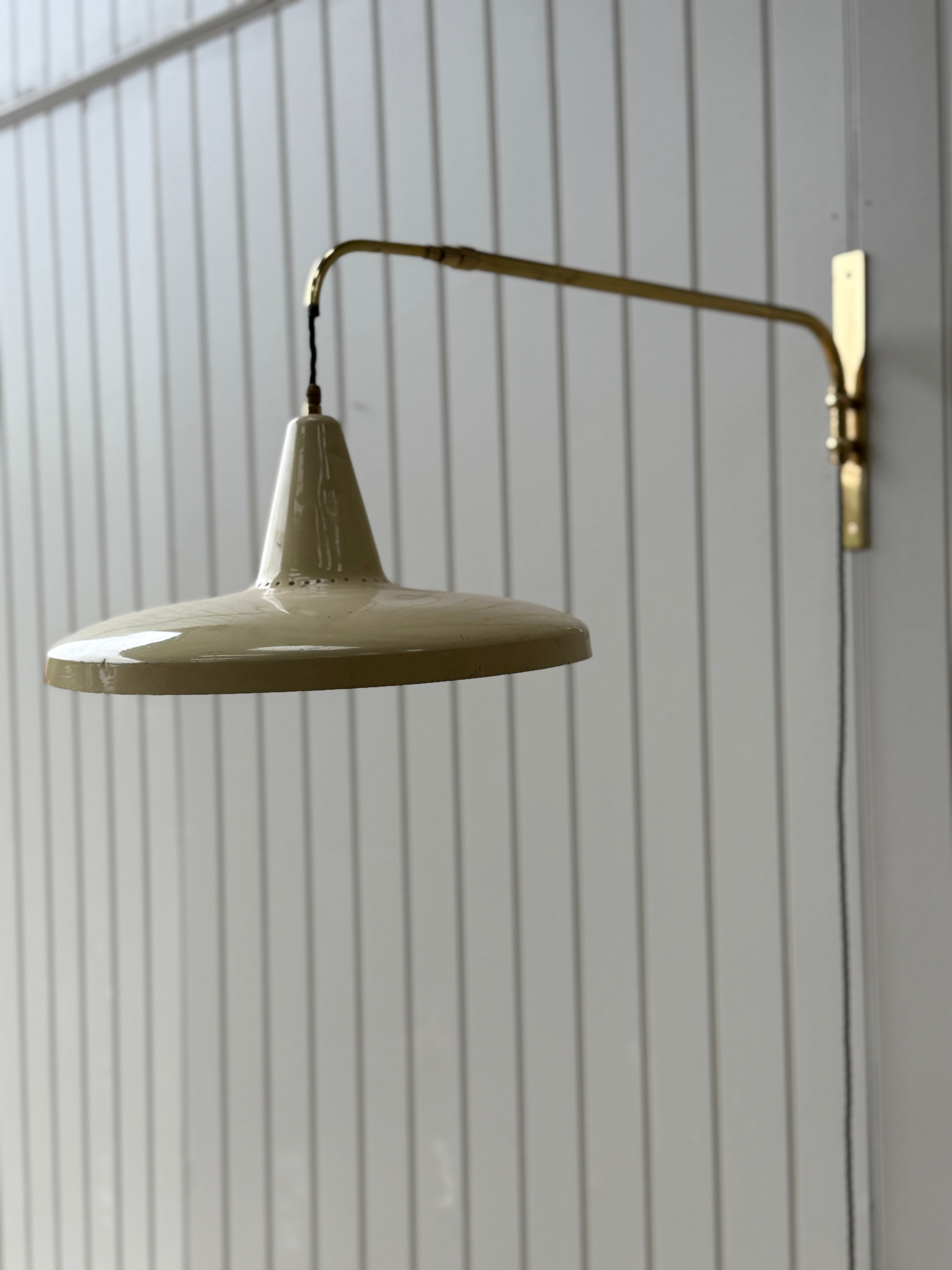 Italian 1950s Extending Brass Wall light with Yellow Toleware shade.
