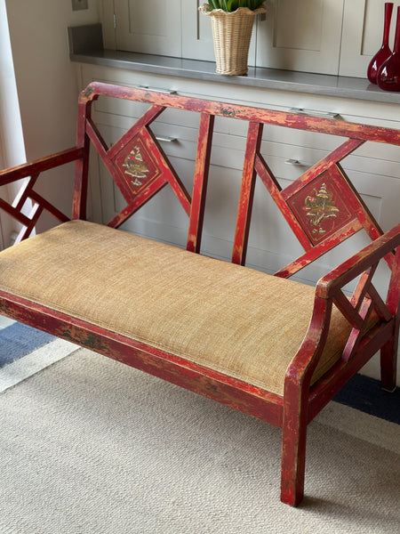 Charming Red Chinoiserie Sofa/Bench with well worn decorative paintwork.