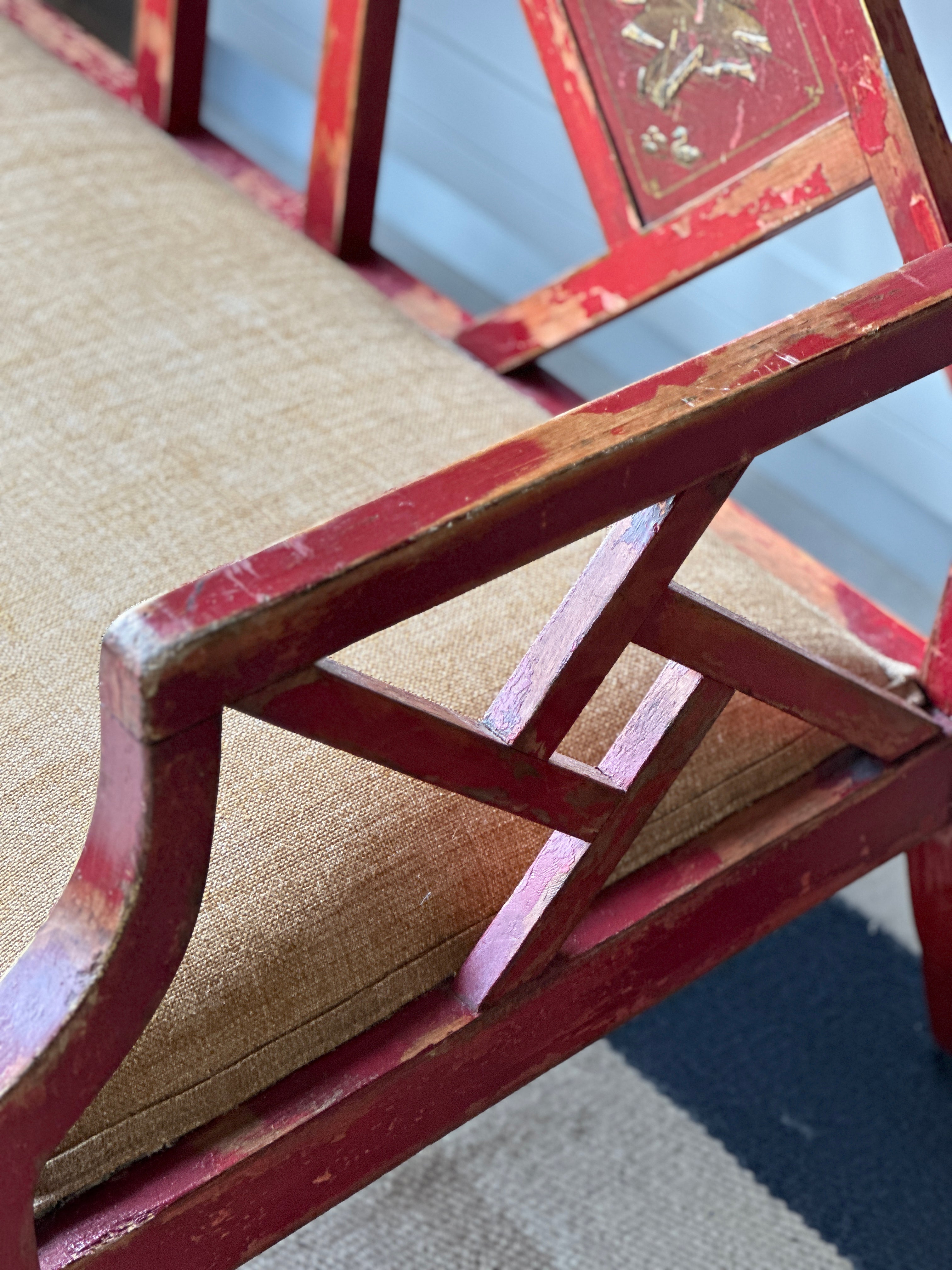 Charming Red Chinoiserie Sofa/Bench with well worn decorative paintwork.