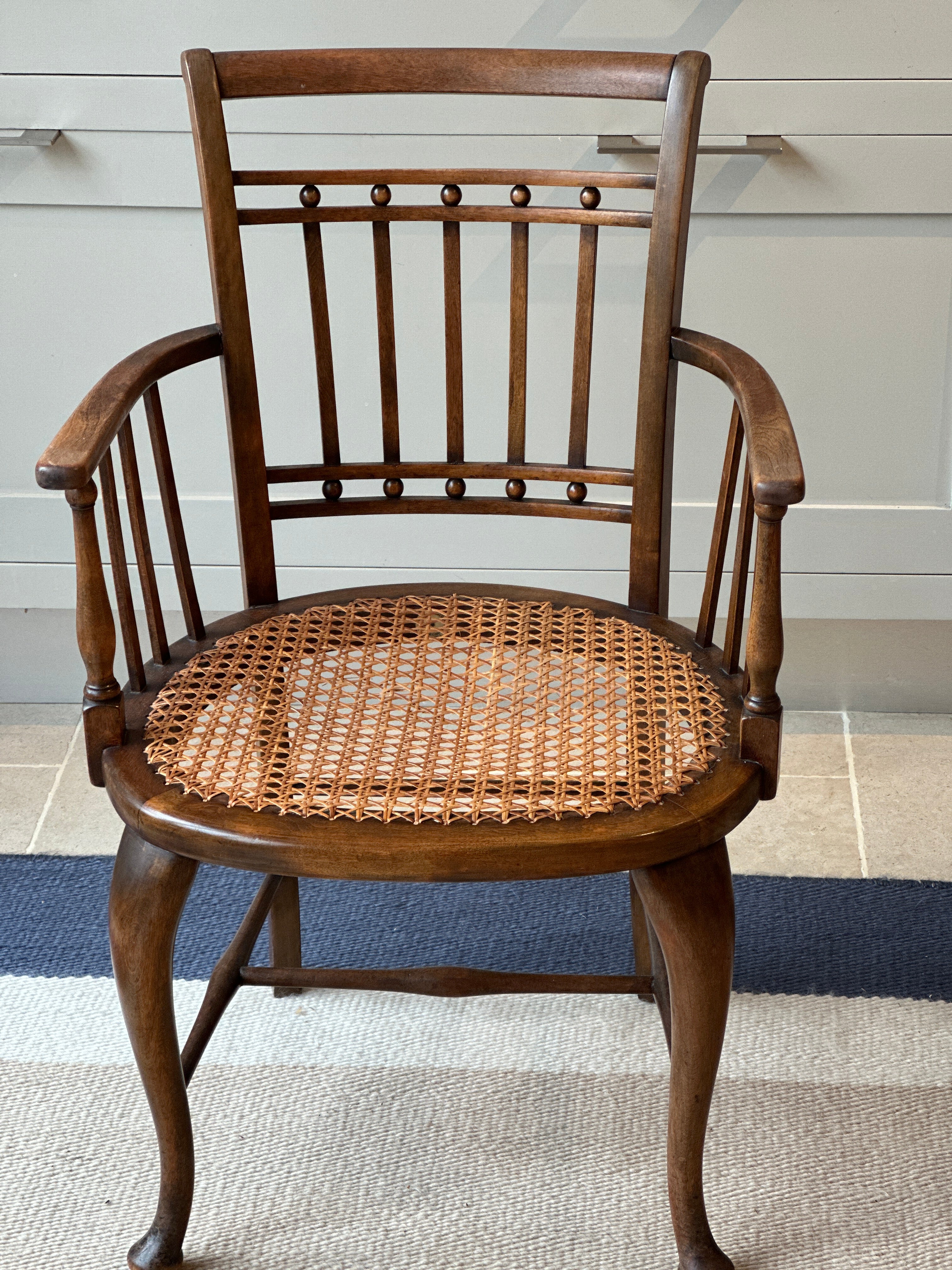 A Small Vintage JAS Shoolbred & Co Spindle Chair with Cane