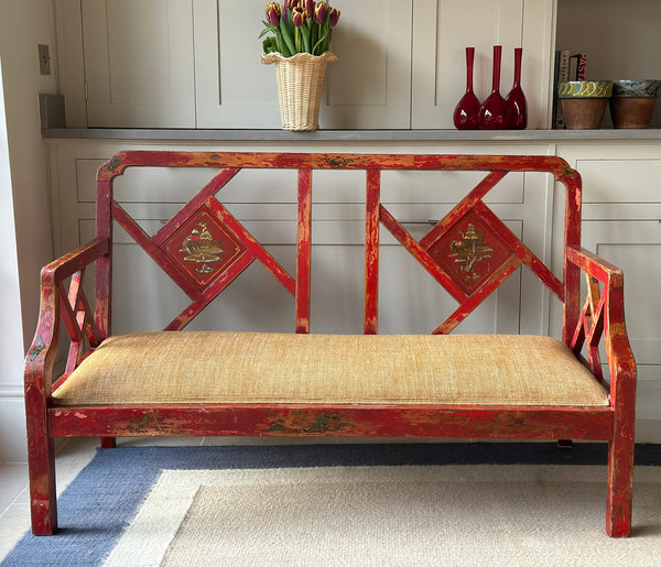 Charming Red Chinoiserie Sofa/Bench with well worn decorative paintwork.