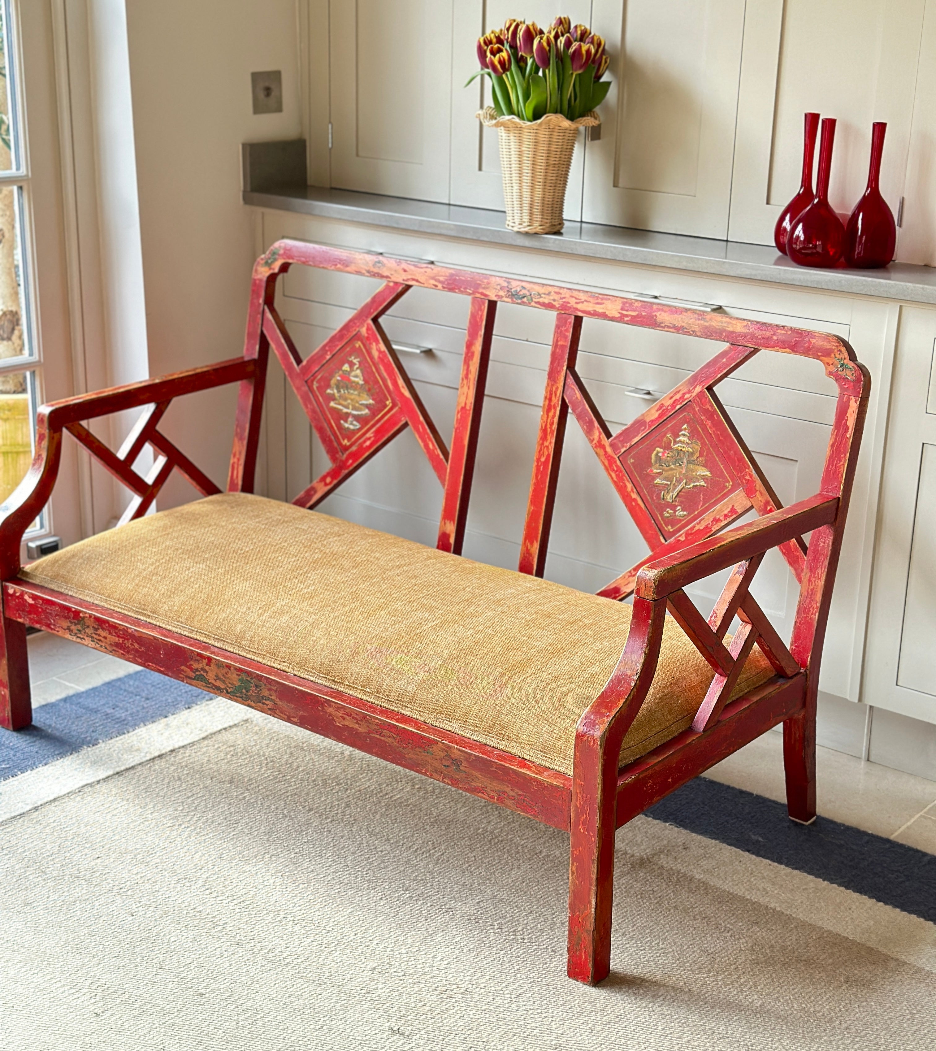 Charming Red Chinoiserie Sofa/Bench with well worn decorative paintwork.