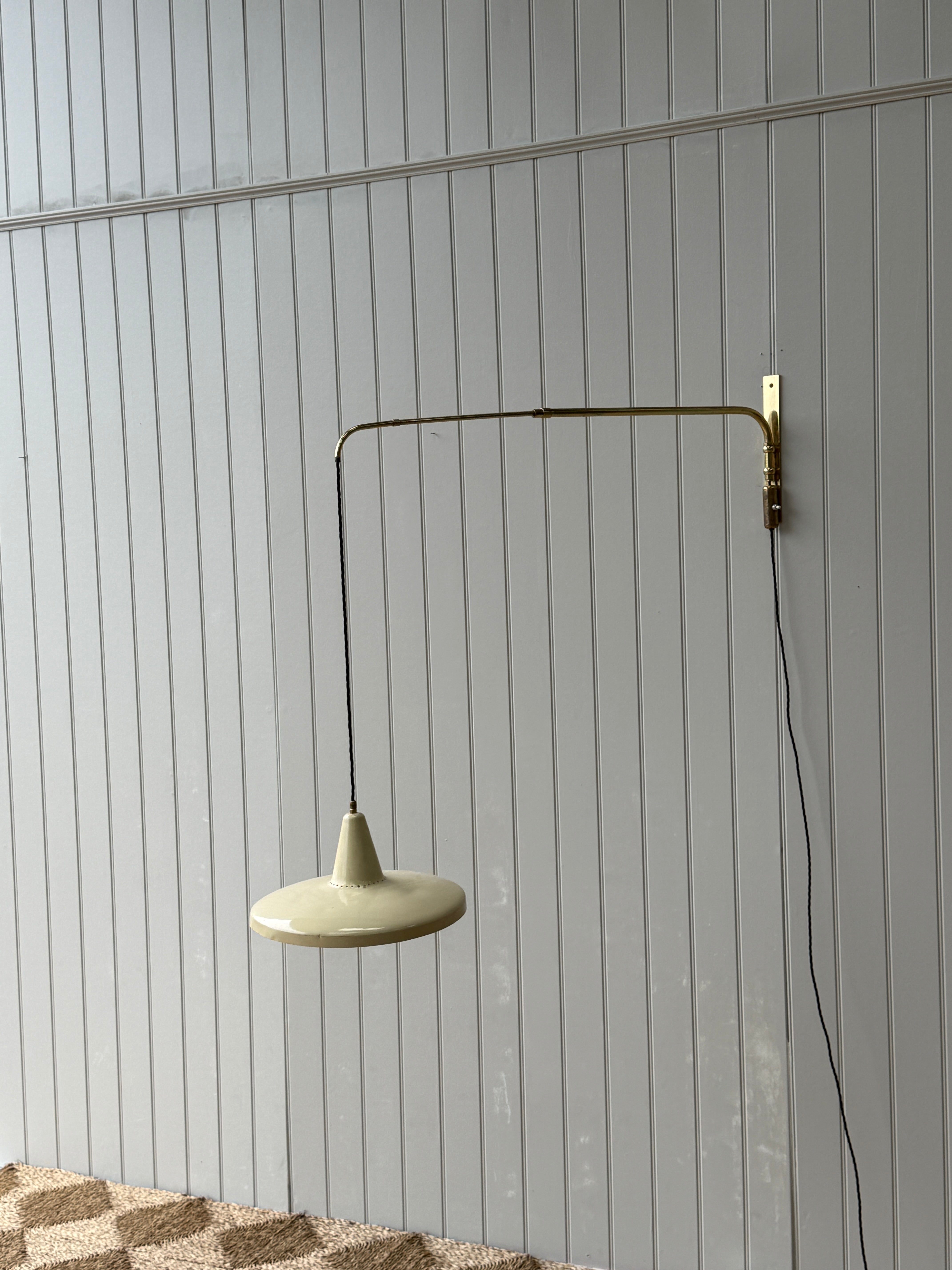 Italian 1950s Extending Brass Wall light with Yellow Toleware shade.