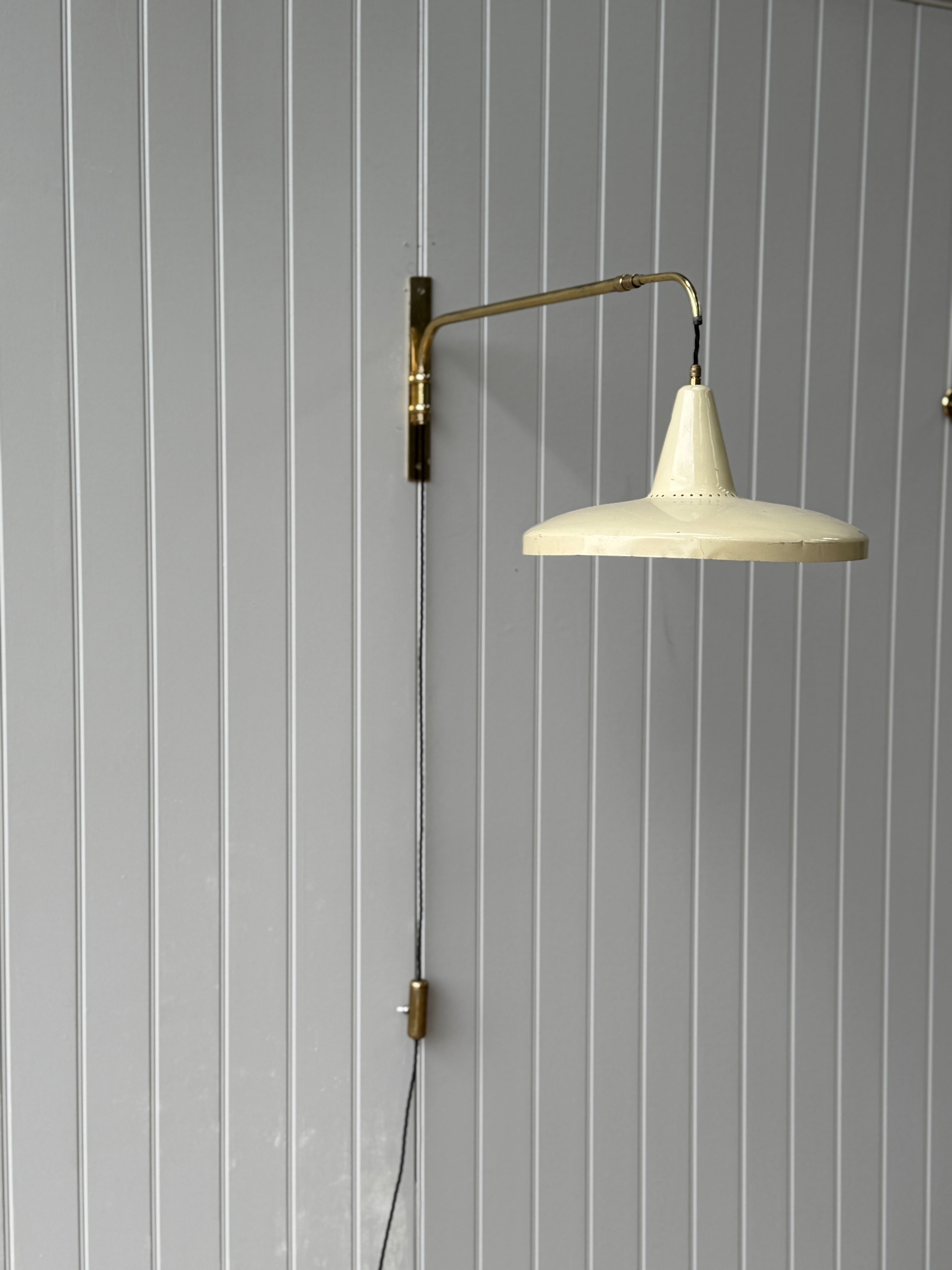 Italian 1950s Extending Brass Wall light with Yellow Toleware shade.