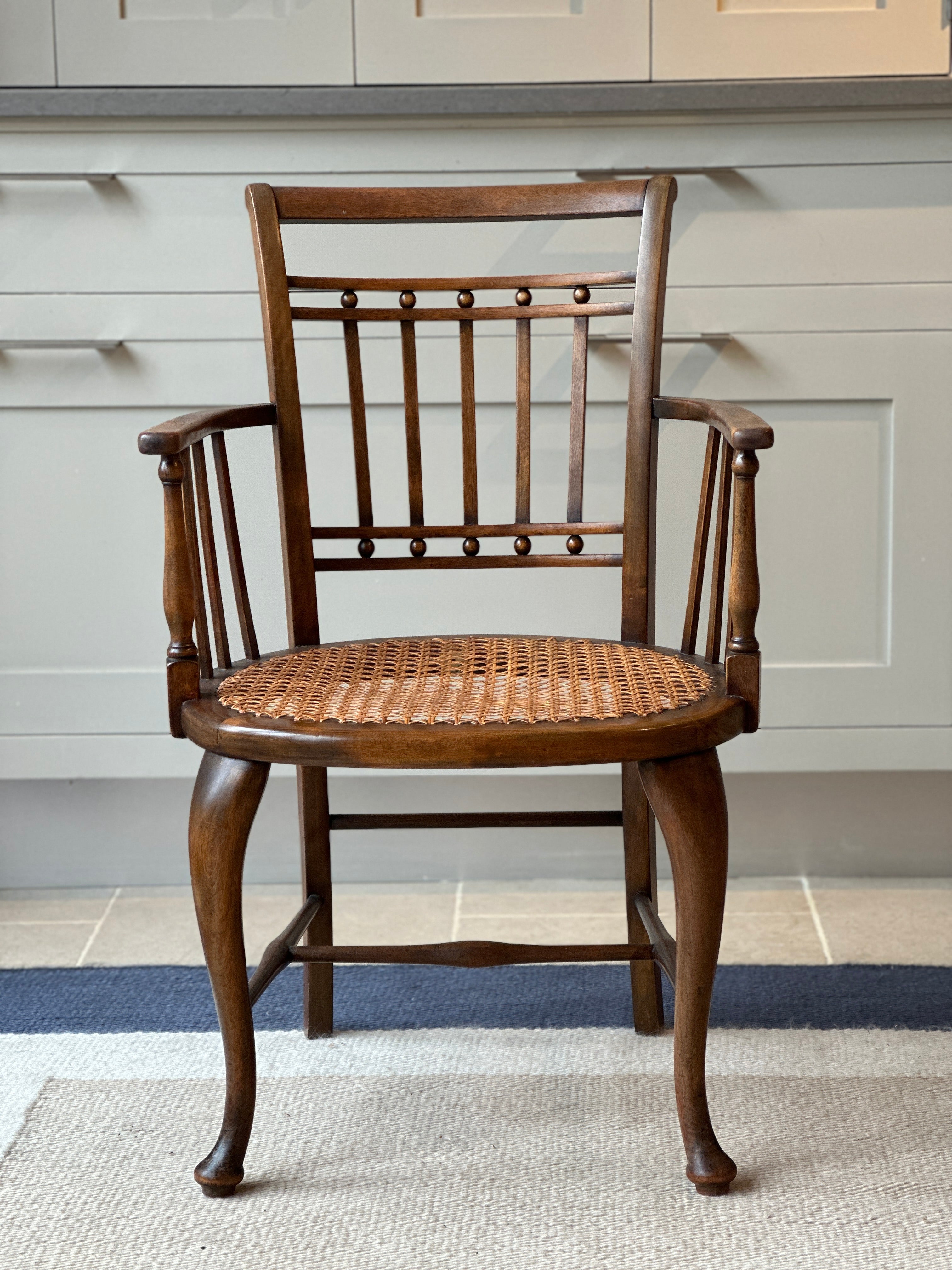 A Small Vintage JAS Shoolbred & Co Spindle Chair with Cane