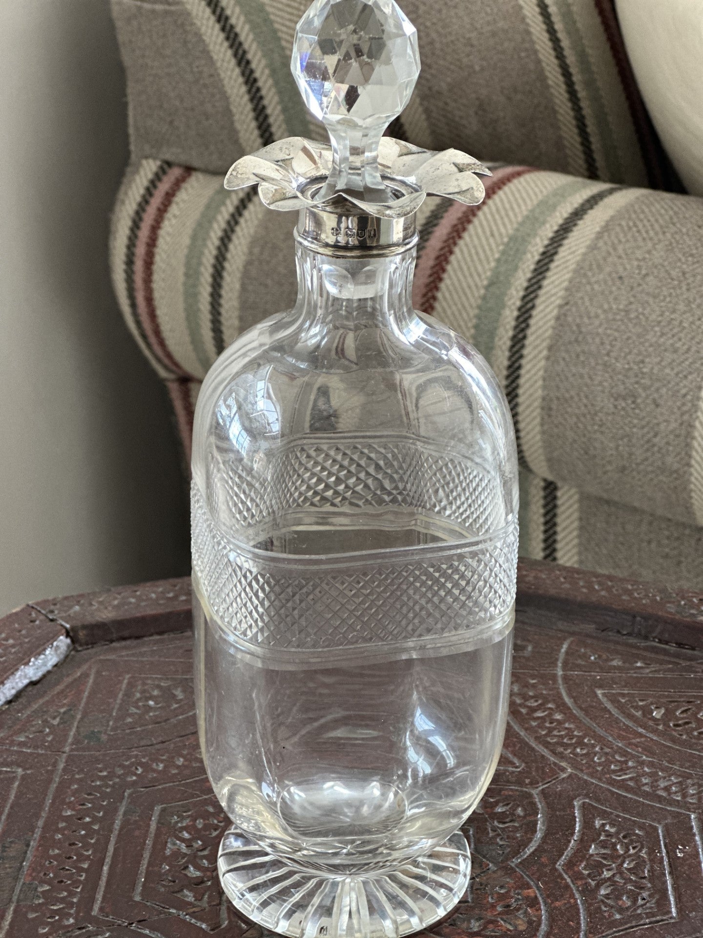 Beautiful cut glass decanter with silver floret top with stopper