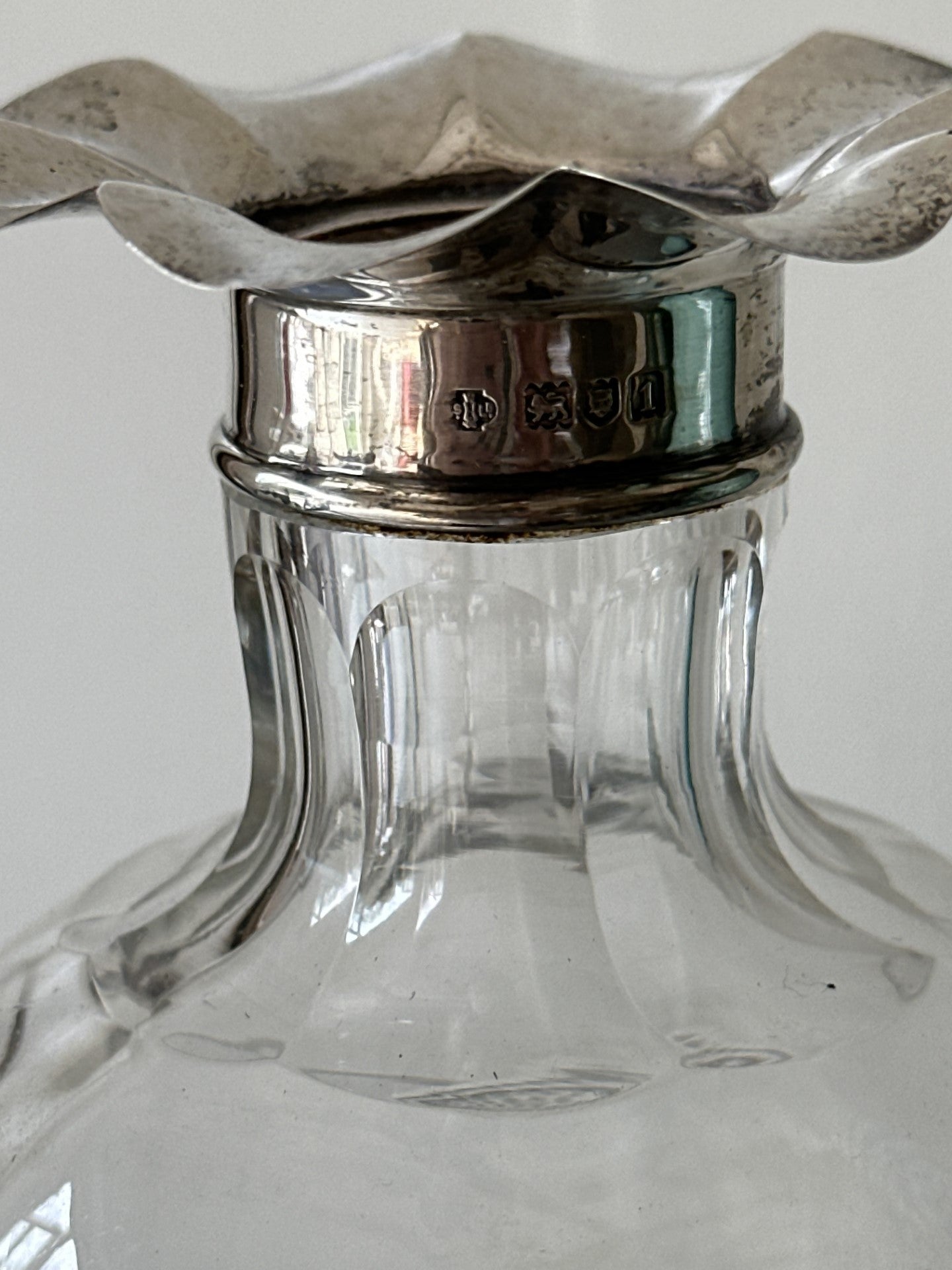 Beautiful cut glass decanter with silver floret top with stopper