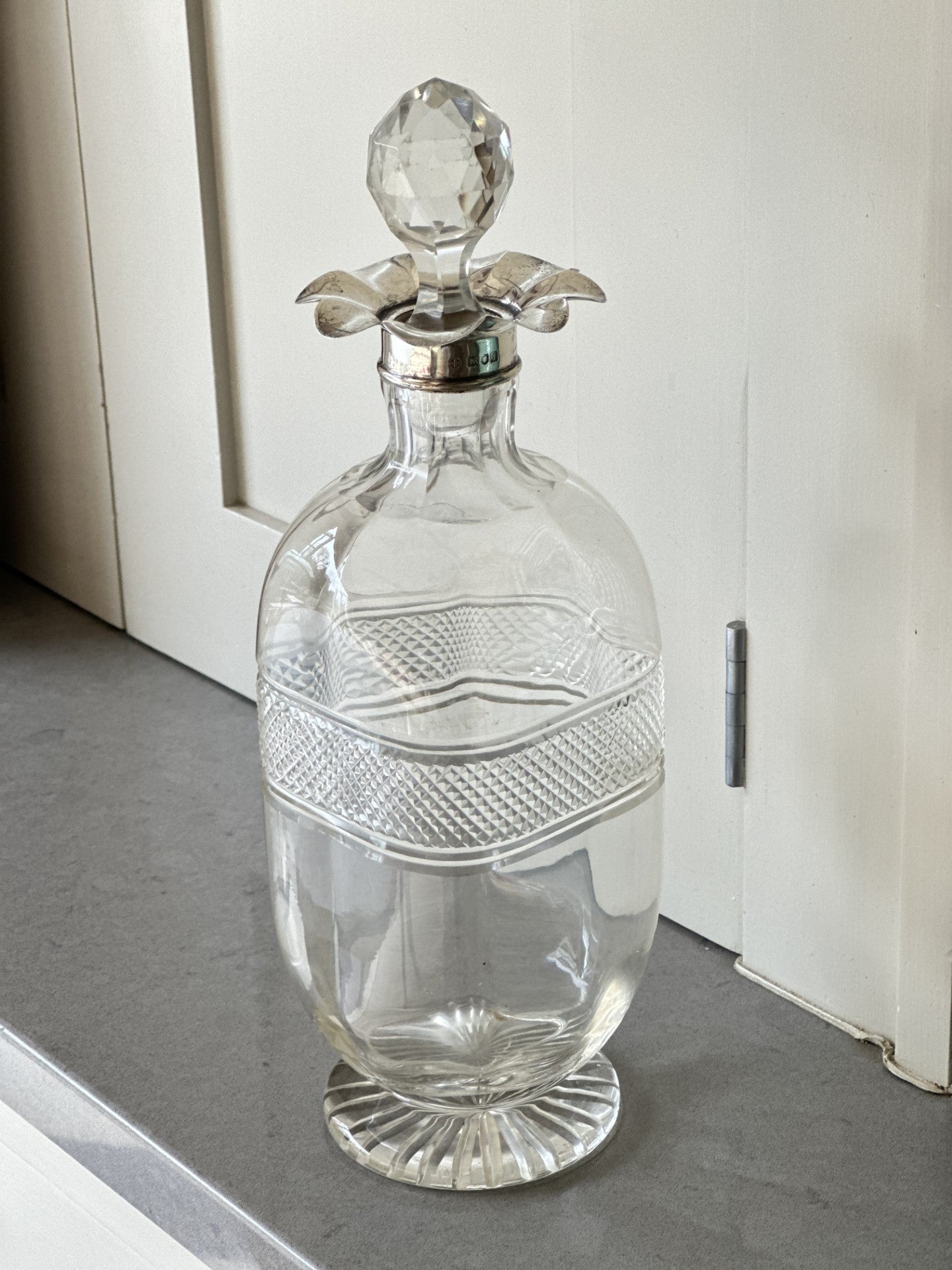 Beautiful cut glass decanter with silver floret top with stopper