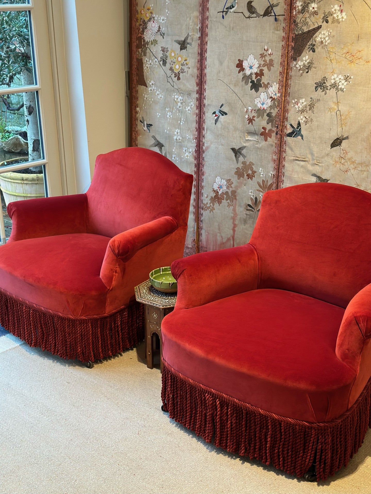 Pair of Chapeaux de Gendarmes chairs in a red velvet material with a Samuel & Sons Astrid Bullion fringe in crimson