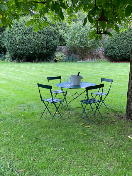 Vintage green bistro table with wooden chairs