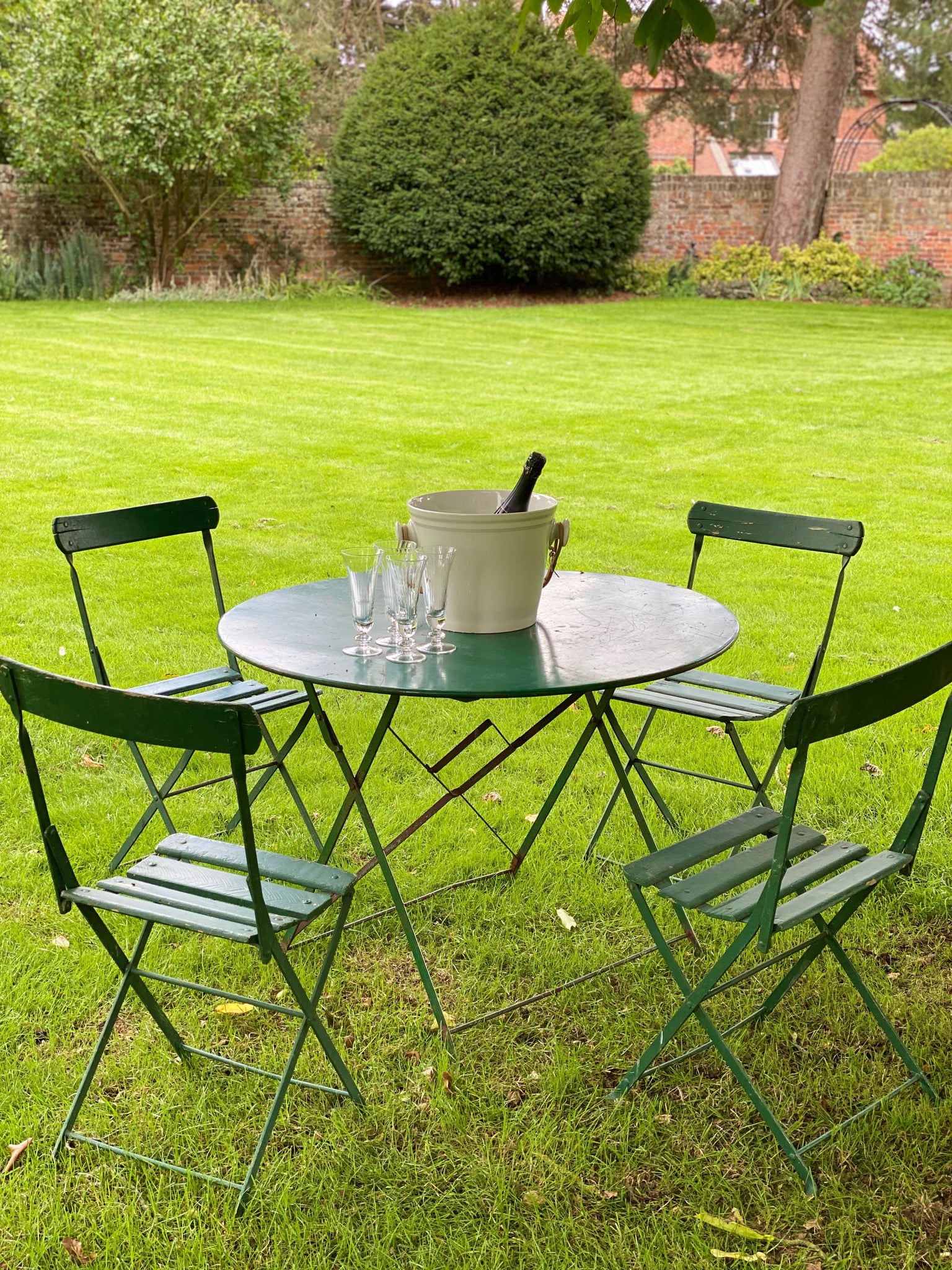 Vintage green bistro table with wooden chairs