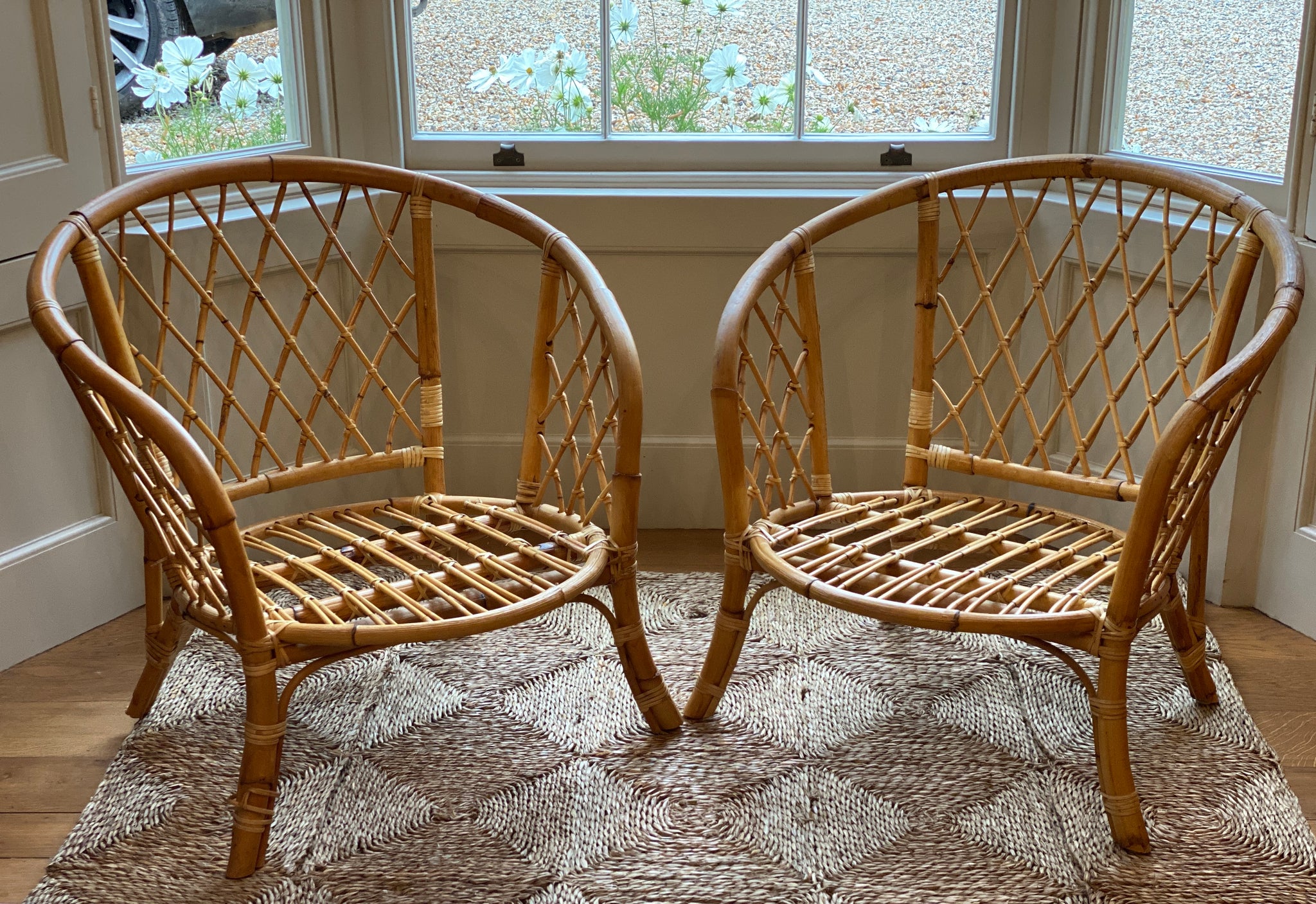 A lovely small pair of vintage cane chairs