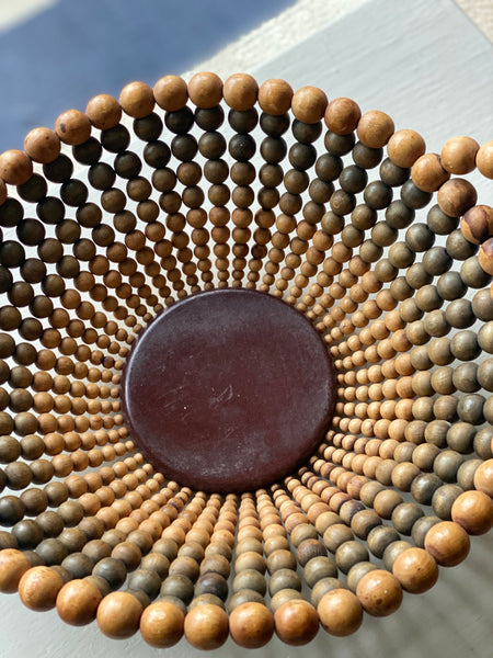 Small decorative bowl or basket constructed of wooden beads