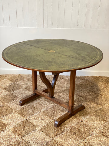 Early C20th French vendange wine table with green leather top.