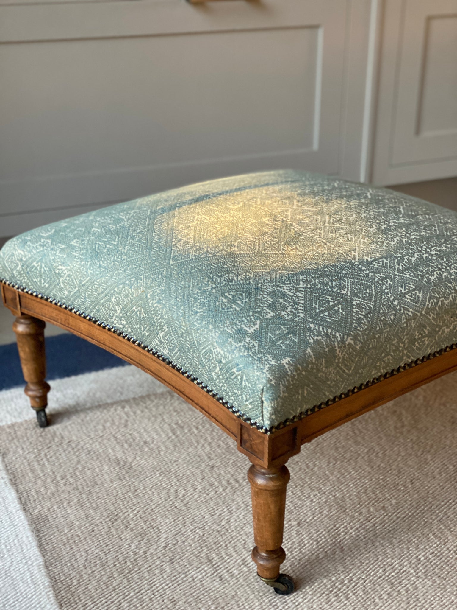 Lovely newly upholstered ottoman footstool on castors