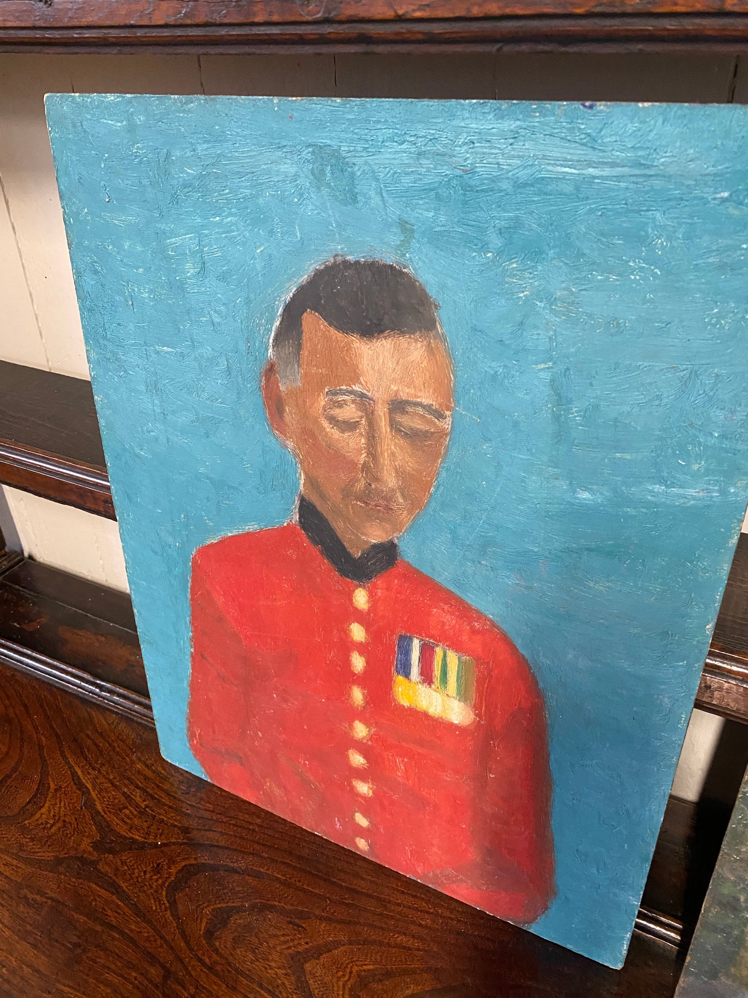 Oil on board naive portrait of man in military uniform.
